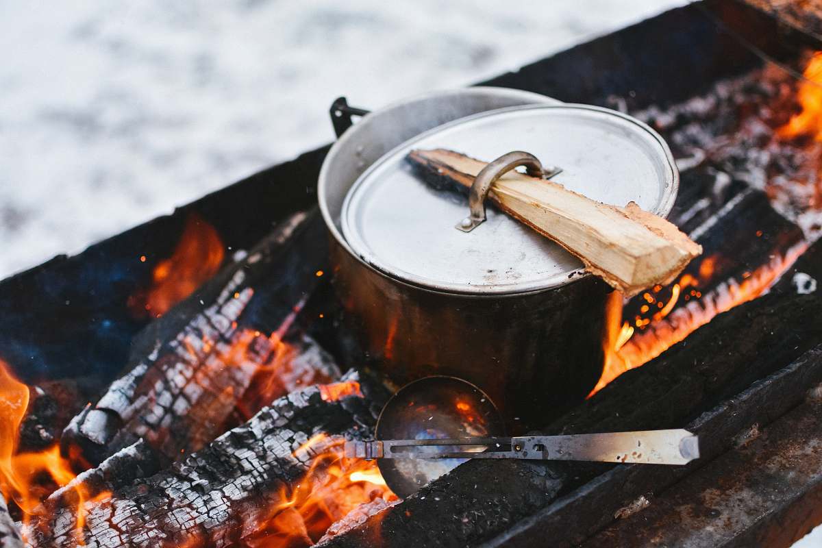 bbq silver cook pot on firewood outdoor