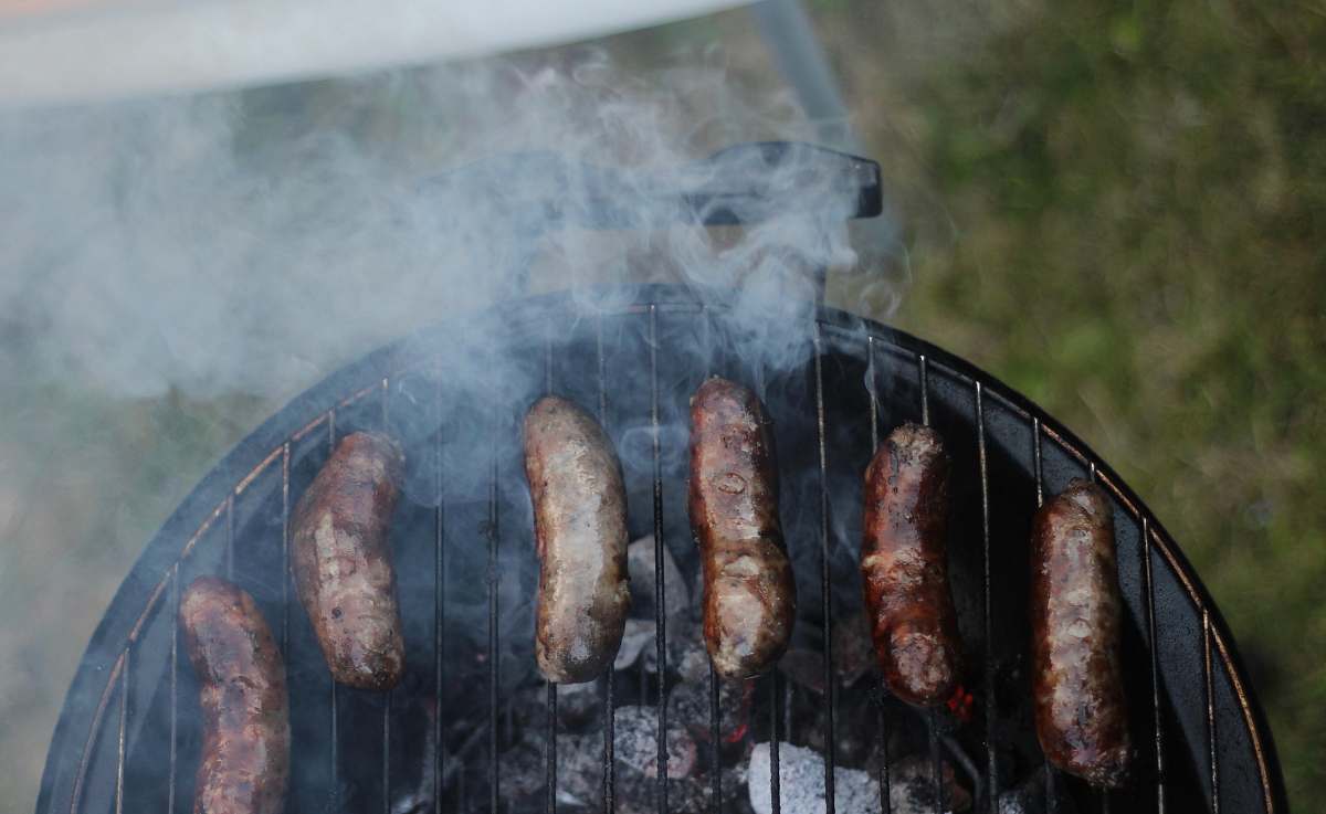 bbq six sausages on black charcoal grill sausages