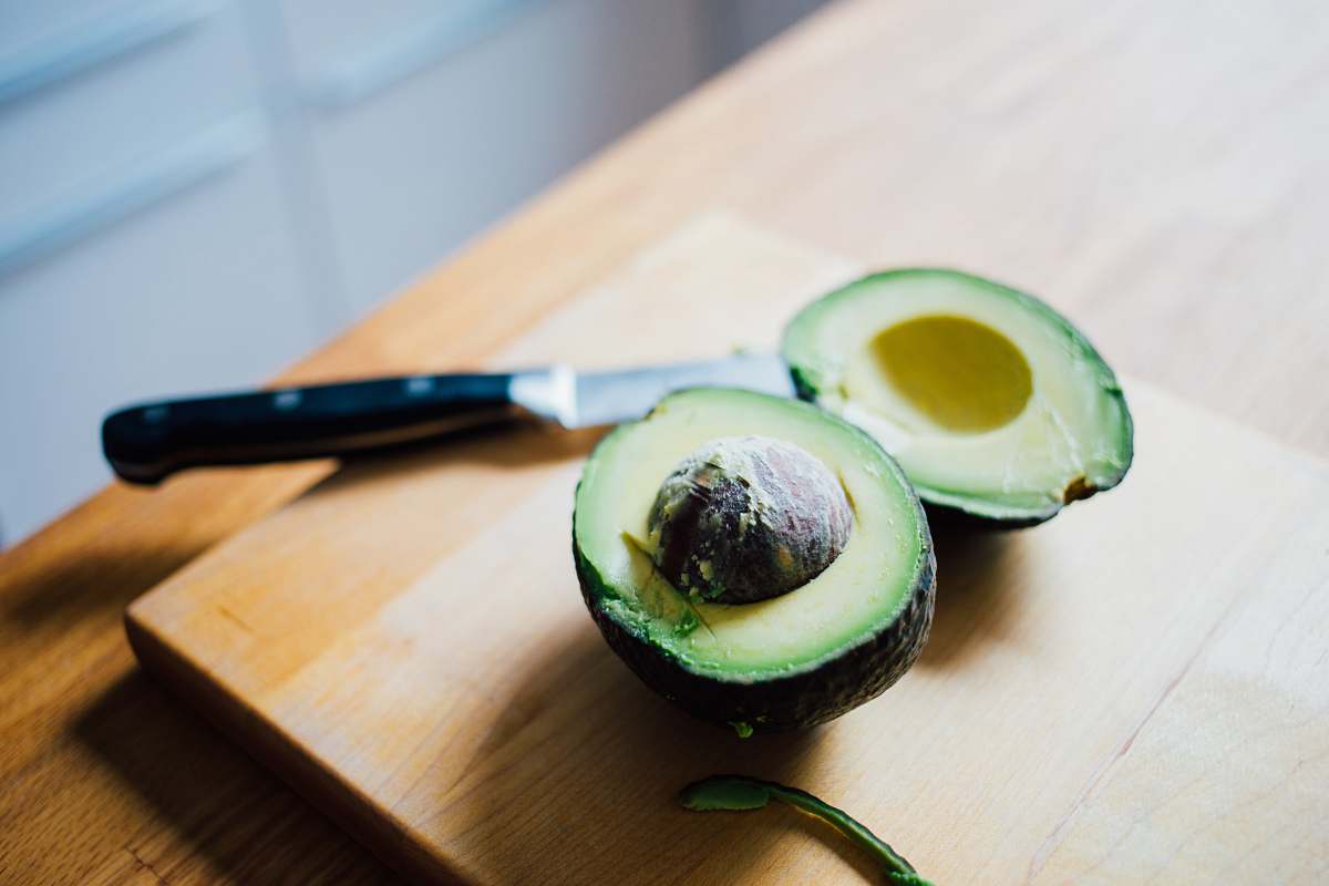 fruit slice of avocado fruit on brown wooden board avocado
