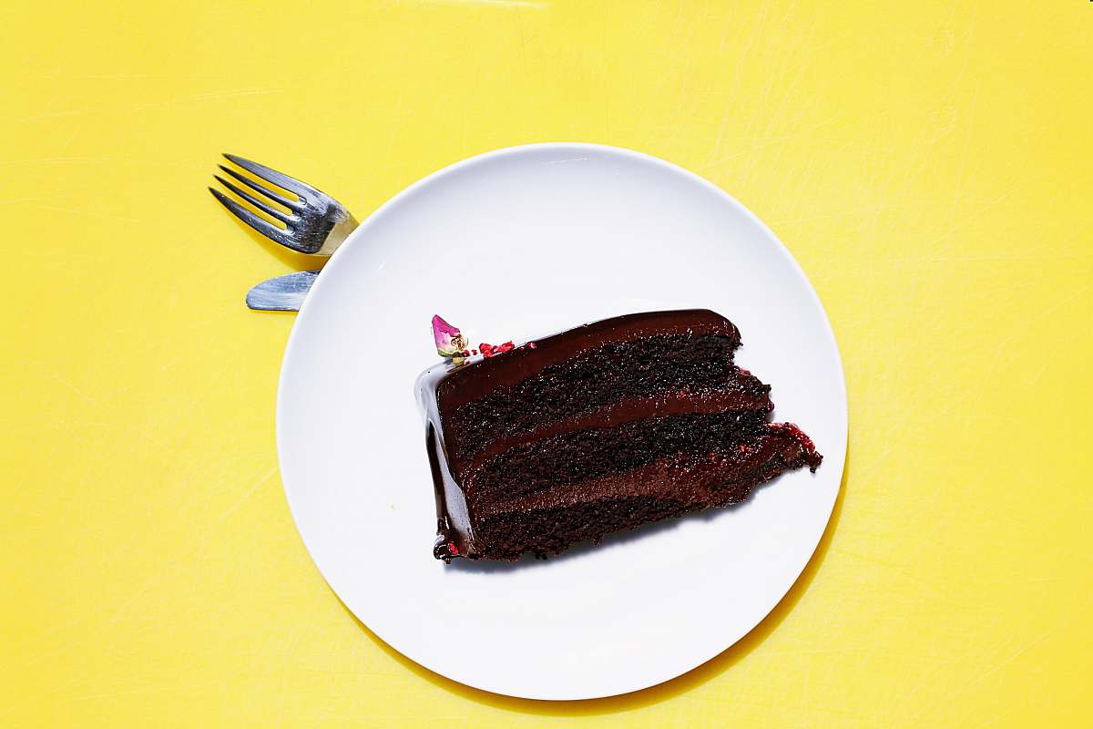 yellow sliced cake on white ceramic saucer fork