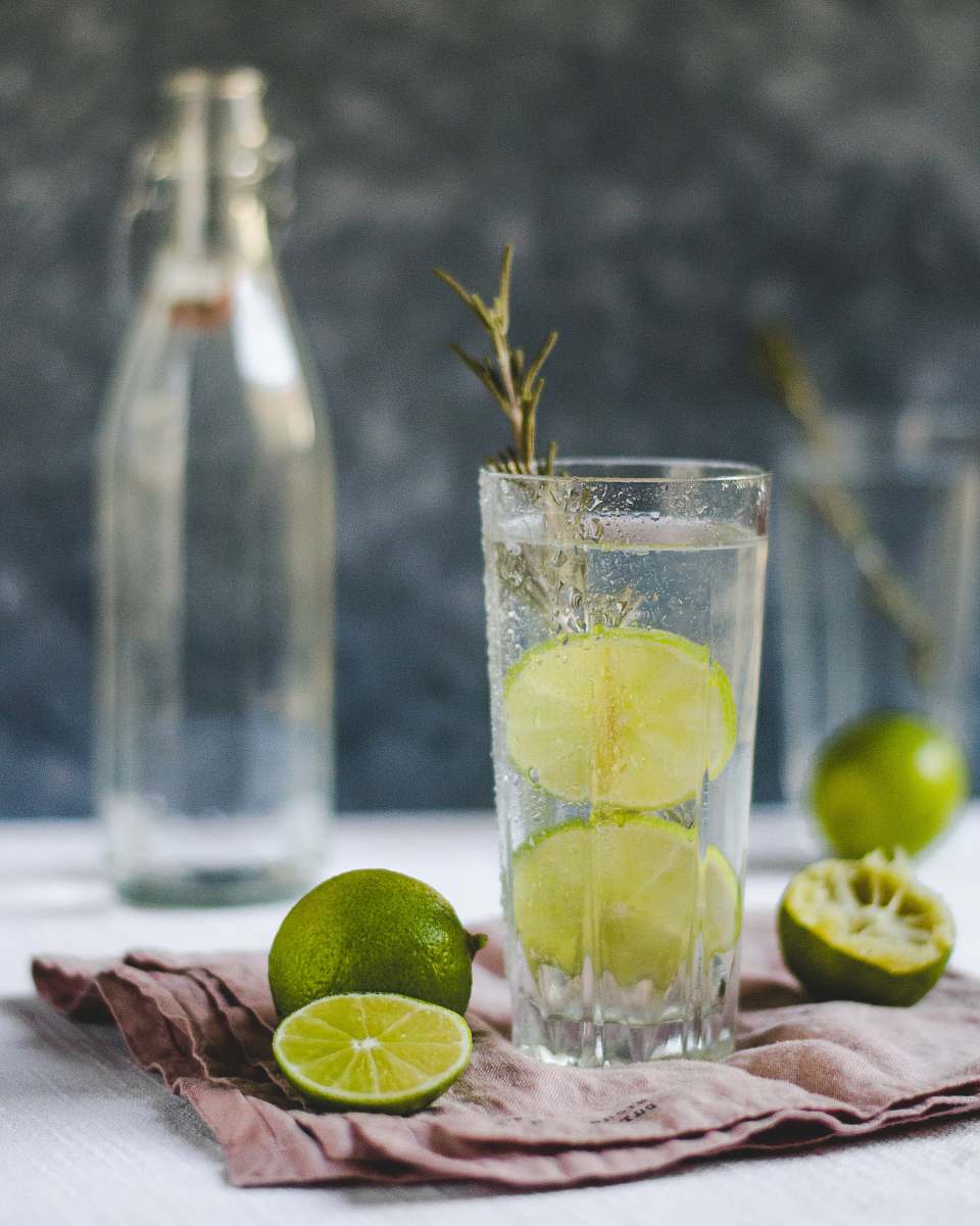 fruit sliced lemons beside drinking glass citrus fruit