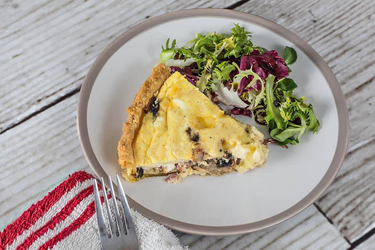 plate sliced pie on white ceramic plate quiche