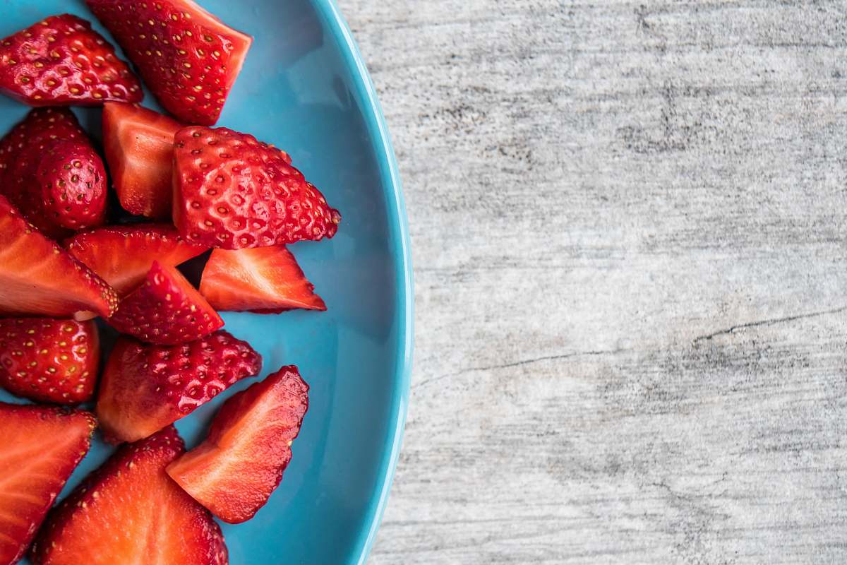 fruit sliced strawberries on teal ceramic plate strawberry