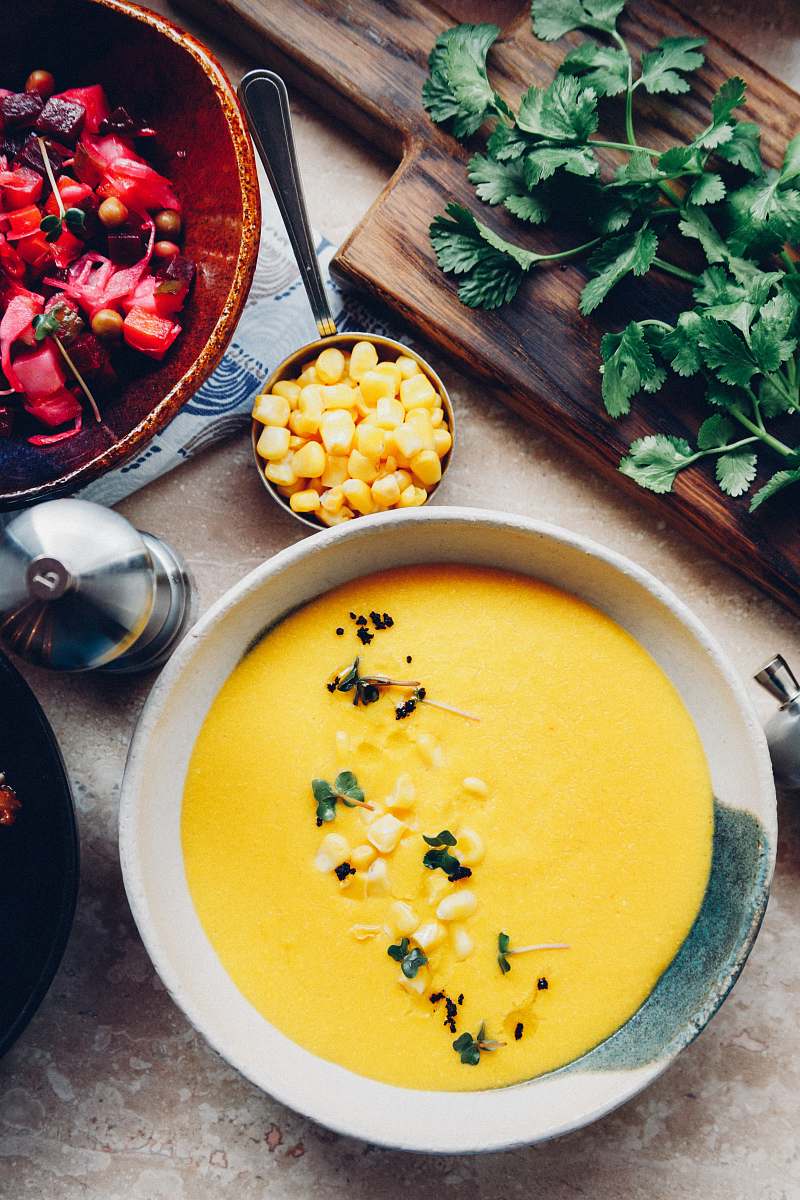 meal soup with garnish in bowl near parsley on chopping board bowl