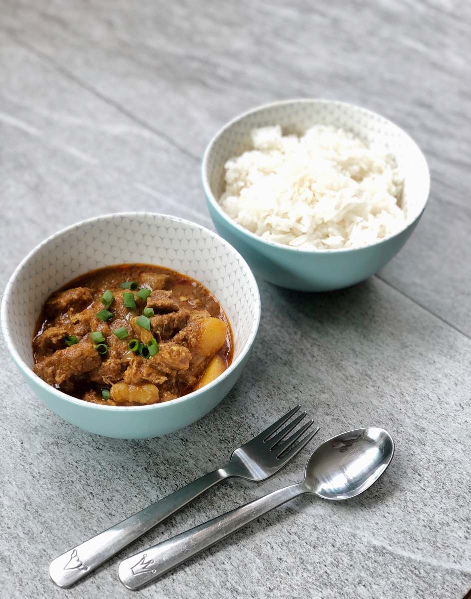bowl spoon and fork beside two white bowls meal