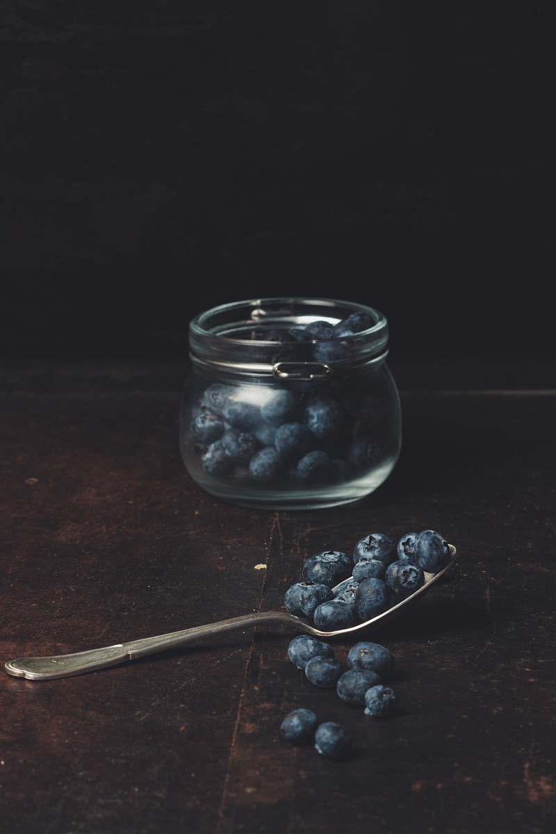 fruit spoonful of blueberries from glass jar blueberry