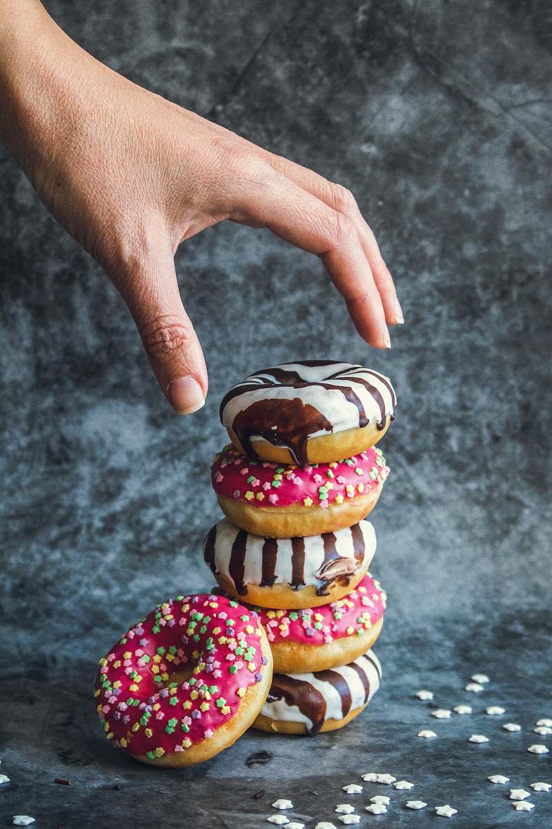sweets stack of doughnuts person