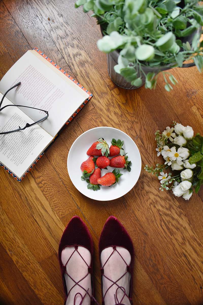 fruit strawberries on bowl beside book strawberry