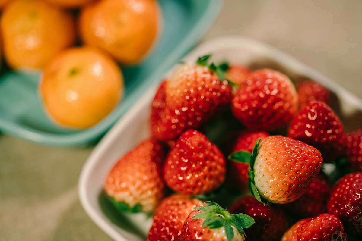 fruit strawberry fruits in bowl and orange fruits in another bowl plant
