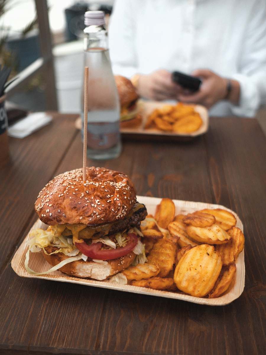 person tasty burger and potato fries on plate human