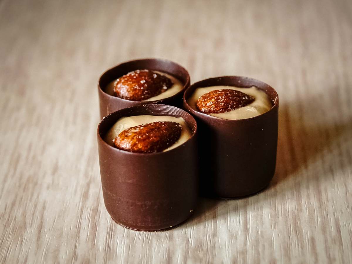 dessert three chocolates with almonds on top sweets