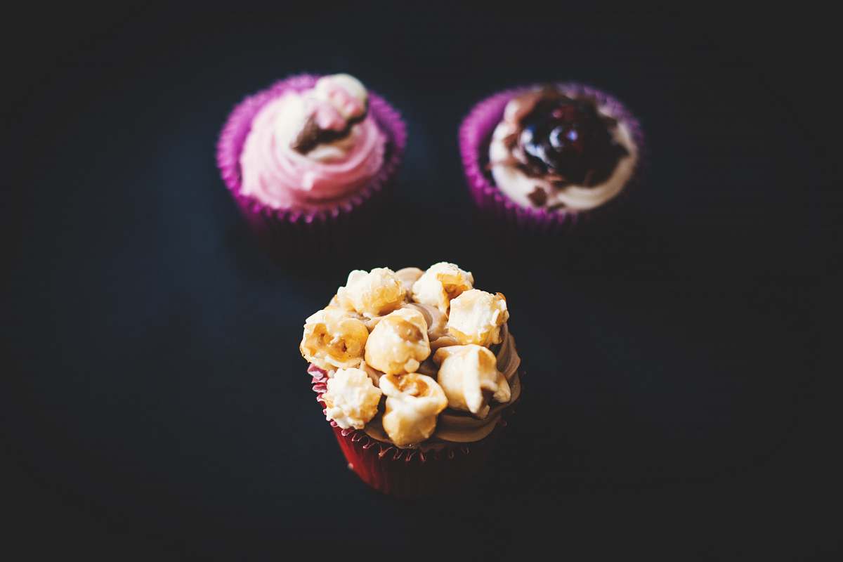 popcorn three closeup photography of three cupcakes snack