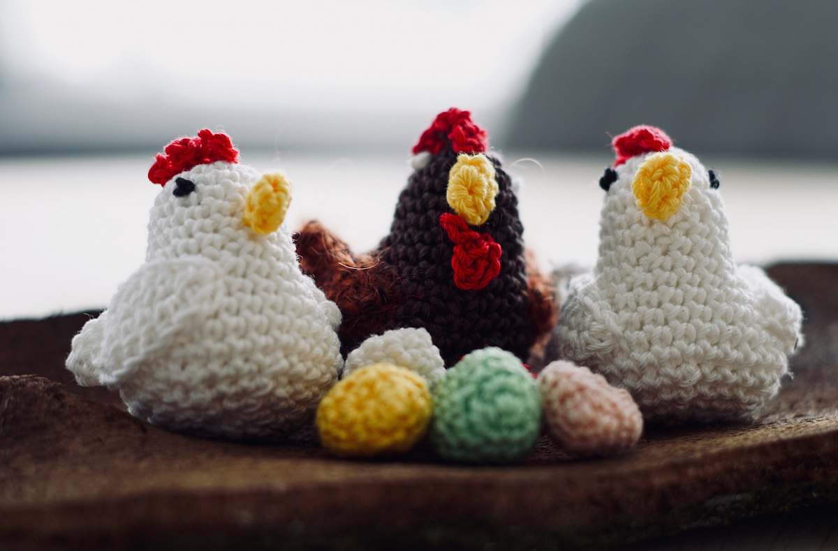 confectionery three knit chicken figures on brown wood sweets