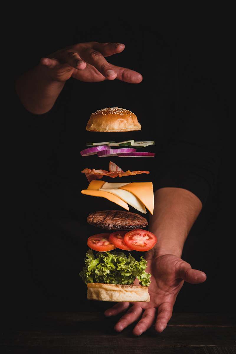 burger timelapse photo of man holding burger human