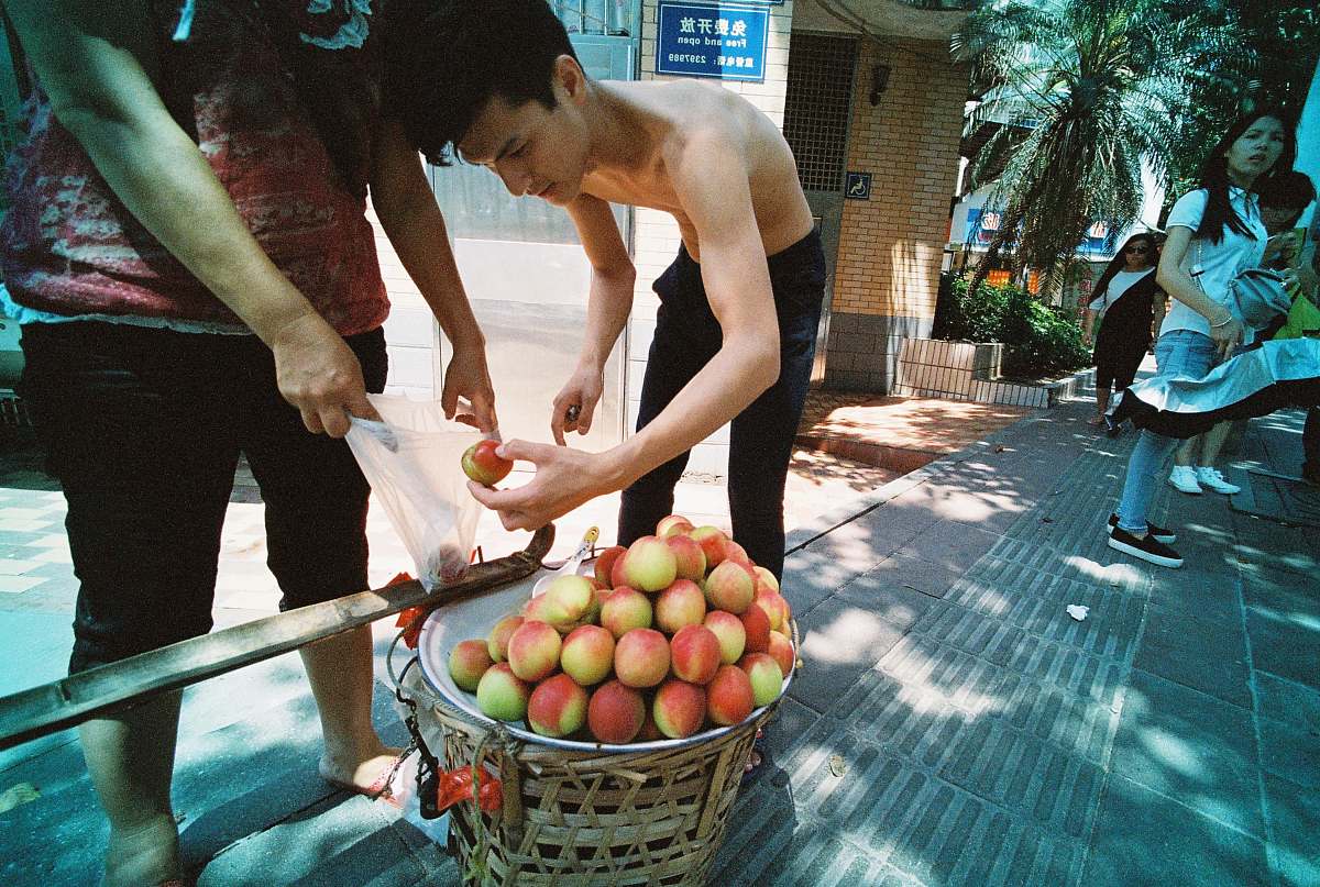 fruit topless man placing apples inside plastic bag apple