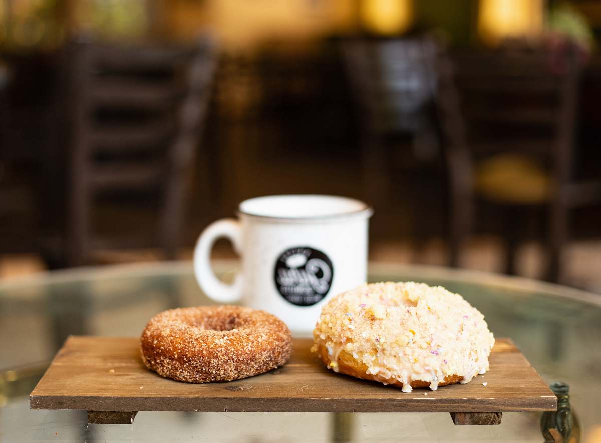 bread two doughnuts on wooden tray bagel
