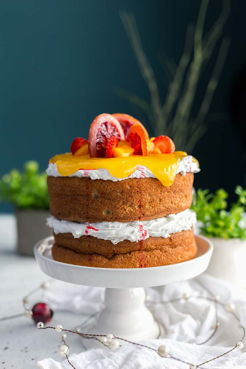 cake two-layered cake with citrus fruit and strawberry toppings dessert