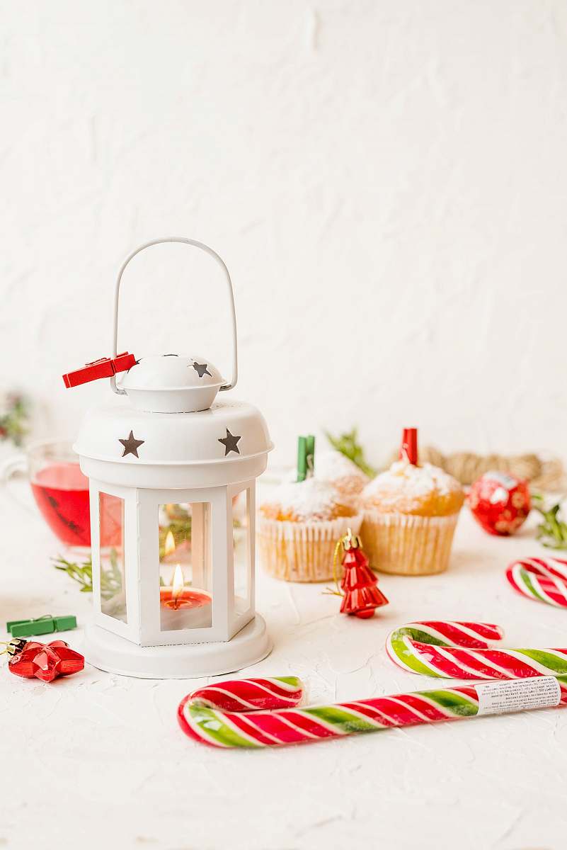 cream white framed candle holder near candy canes and cupcakes cake