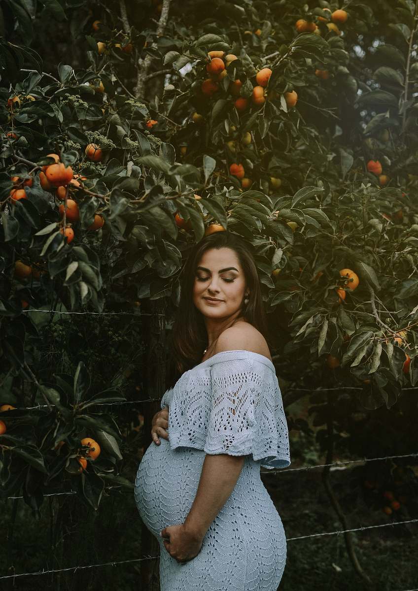 plant woman beside orange tree produce