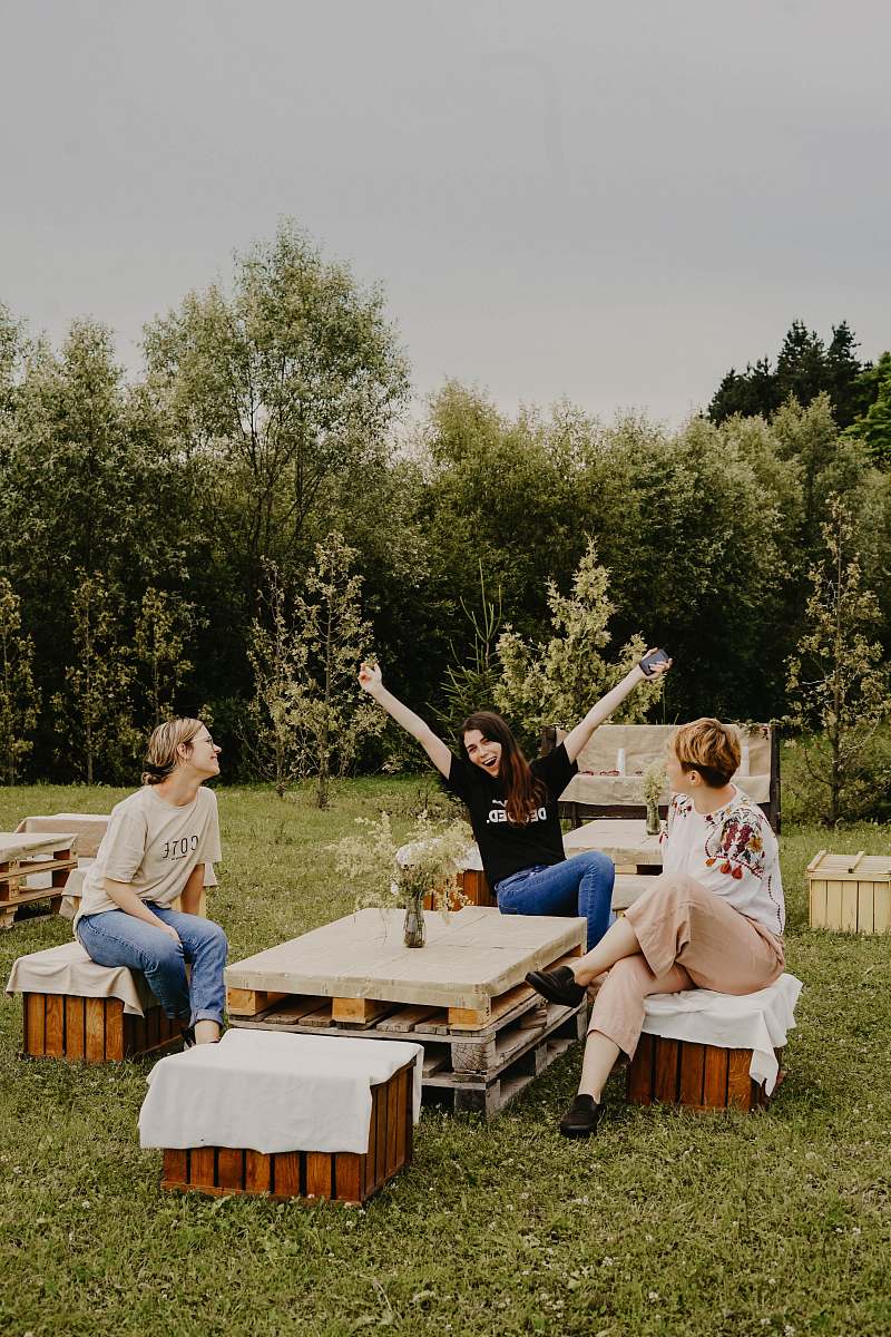 person women sitting on chairs outdoor human