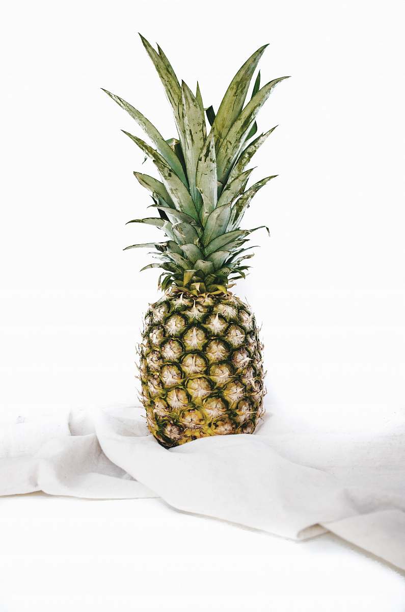 fruit yellow and green pineapple fruit on white textile pineapple