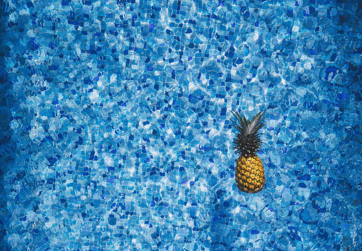 pineapple aerial view photography of pineapple on body of water blue
