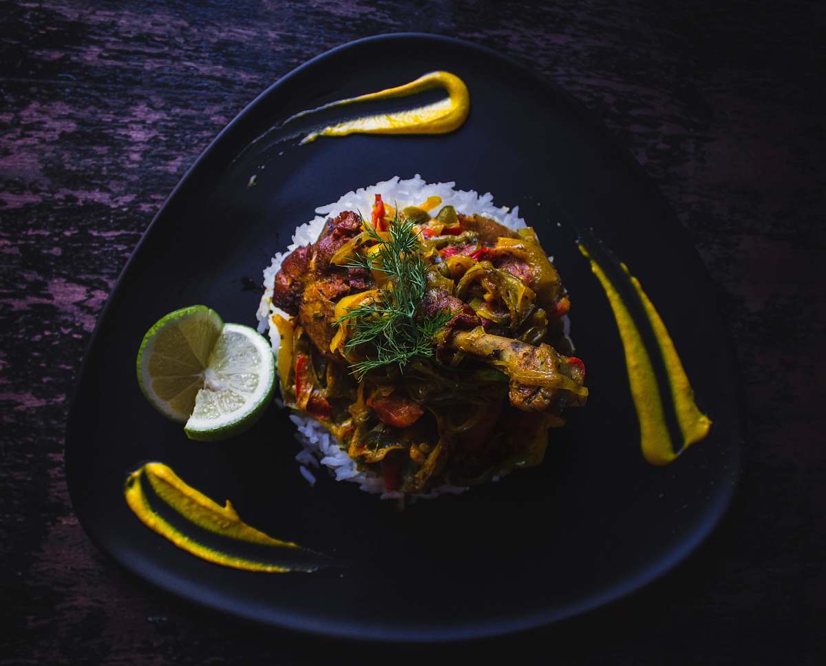 food cooked food served on black plate citrus fruit