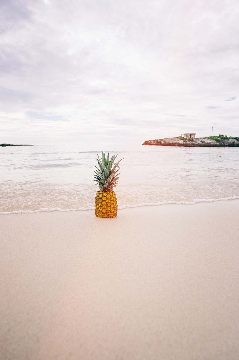 food pineapple on sand near beach fruit