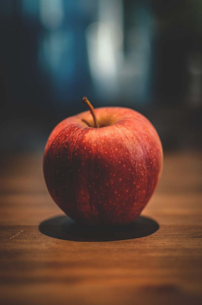 fruit red apple on brown surface apple