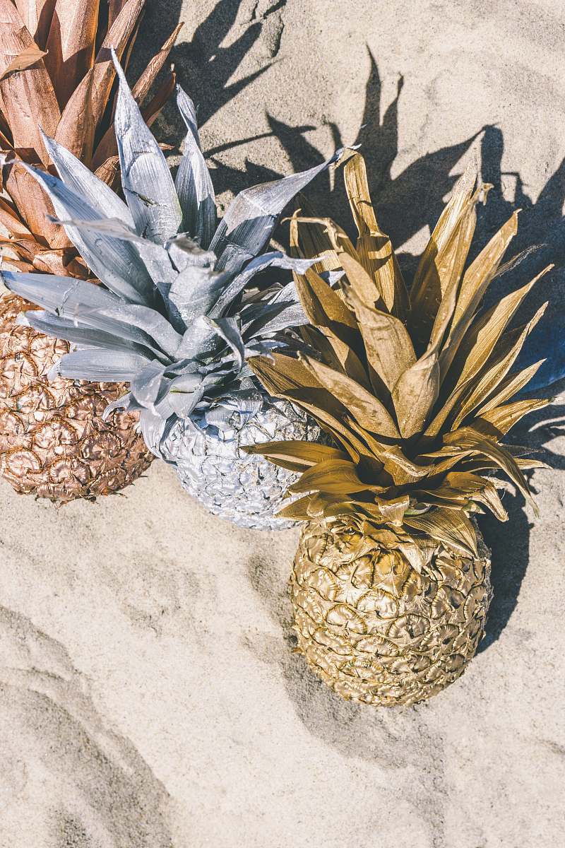 fruit three pineapples on sand pineapple