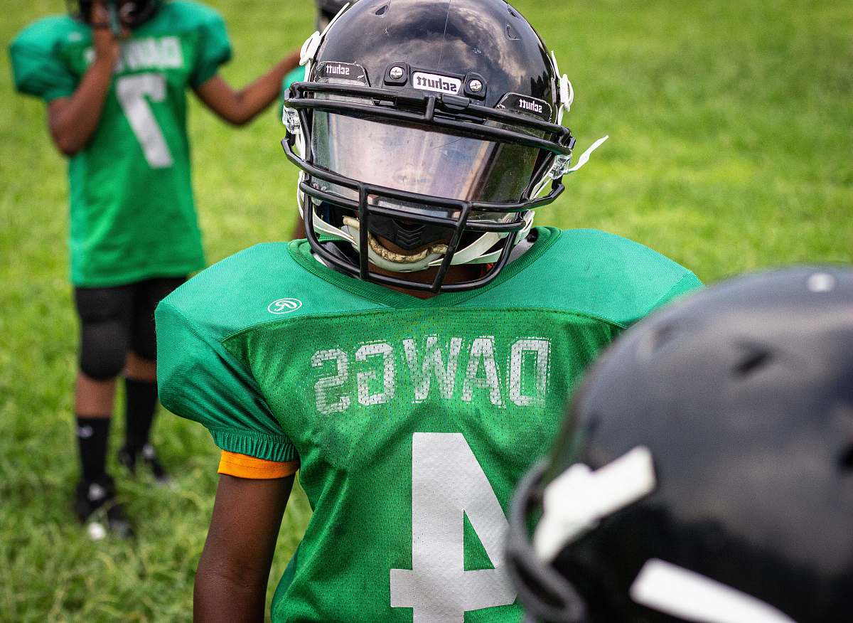 clothing boy wearing green Dawgs 4 jersey wearing black helmet helmet