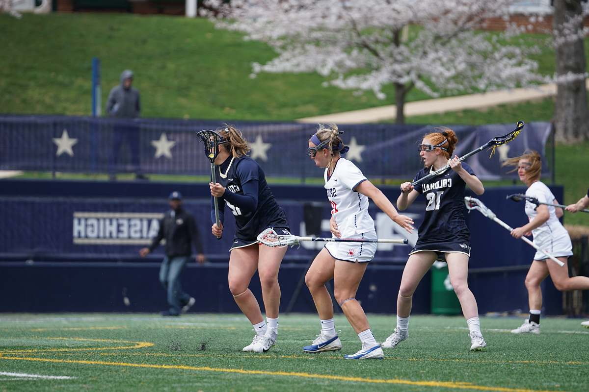 human four woman playing lacrosse sticks person