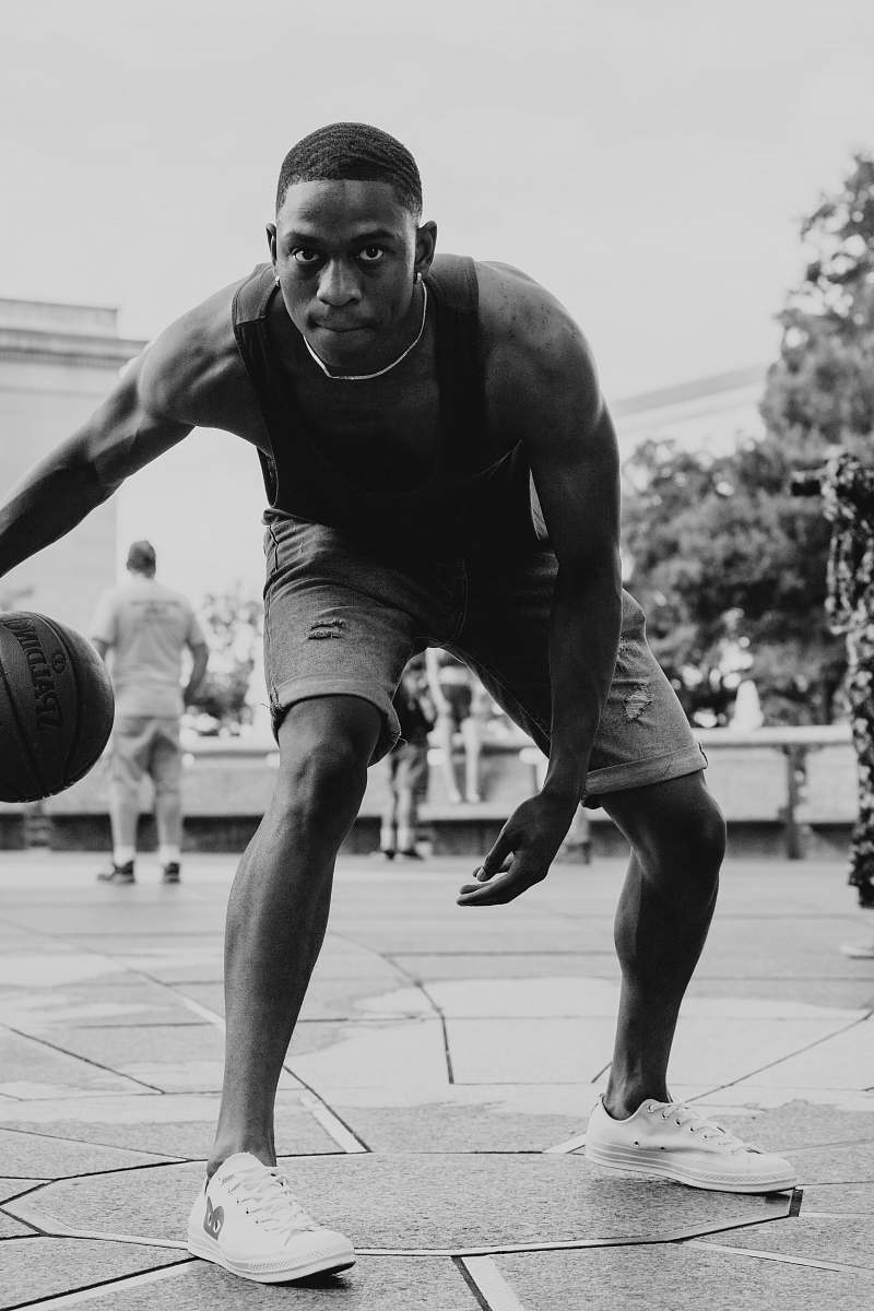 clothing grayscale photo of man playing basketball black-and-white