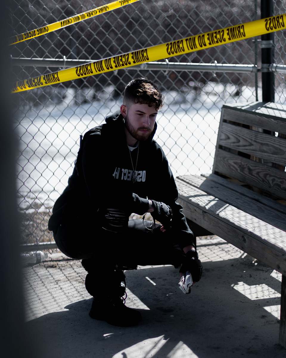 human man in black jacket beside bench person