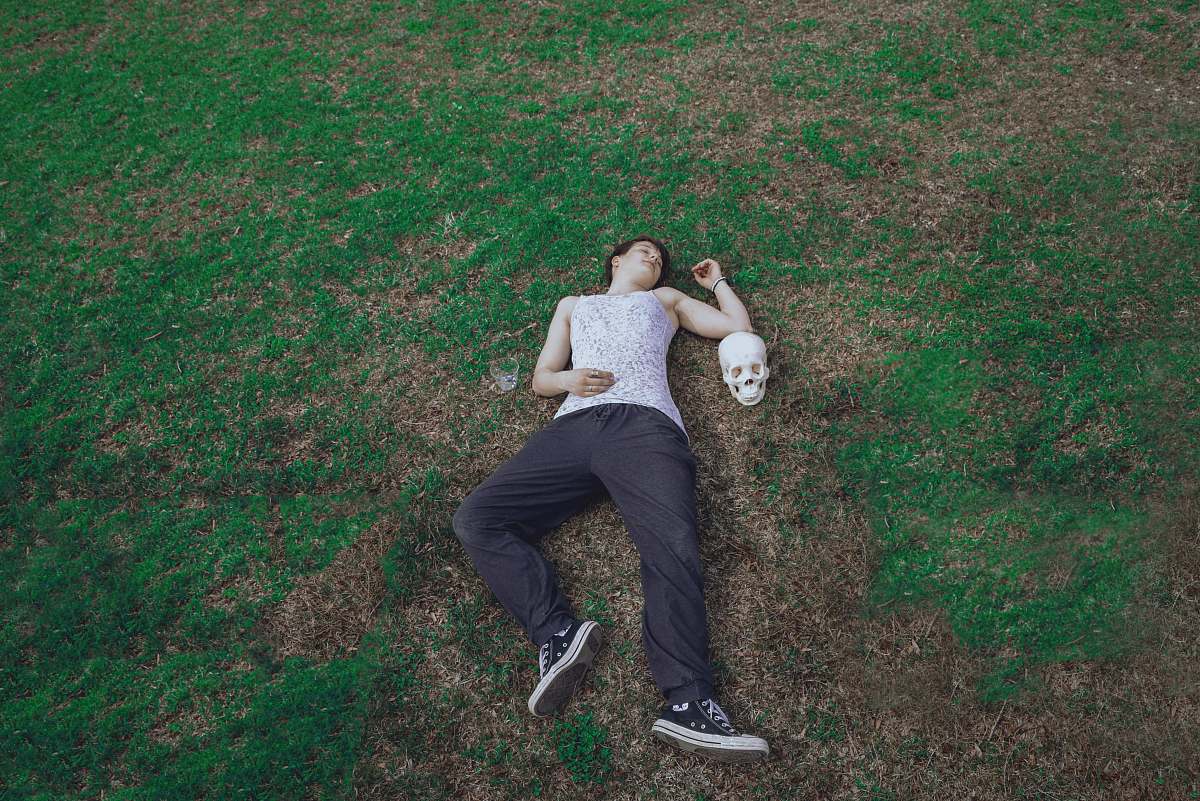 clothing man lying on ground footwear