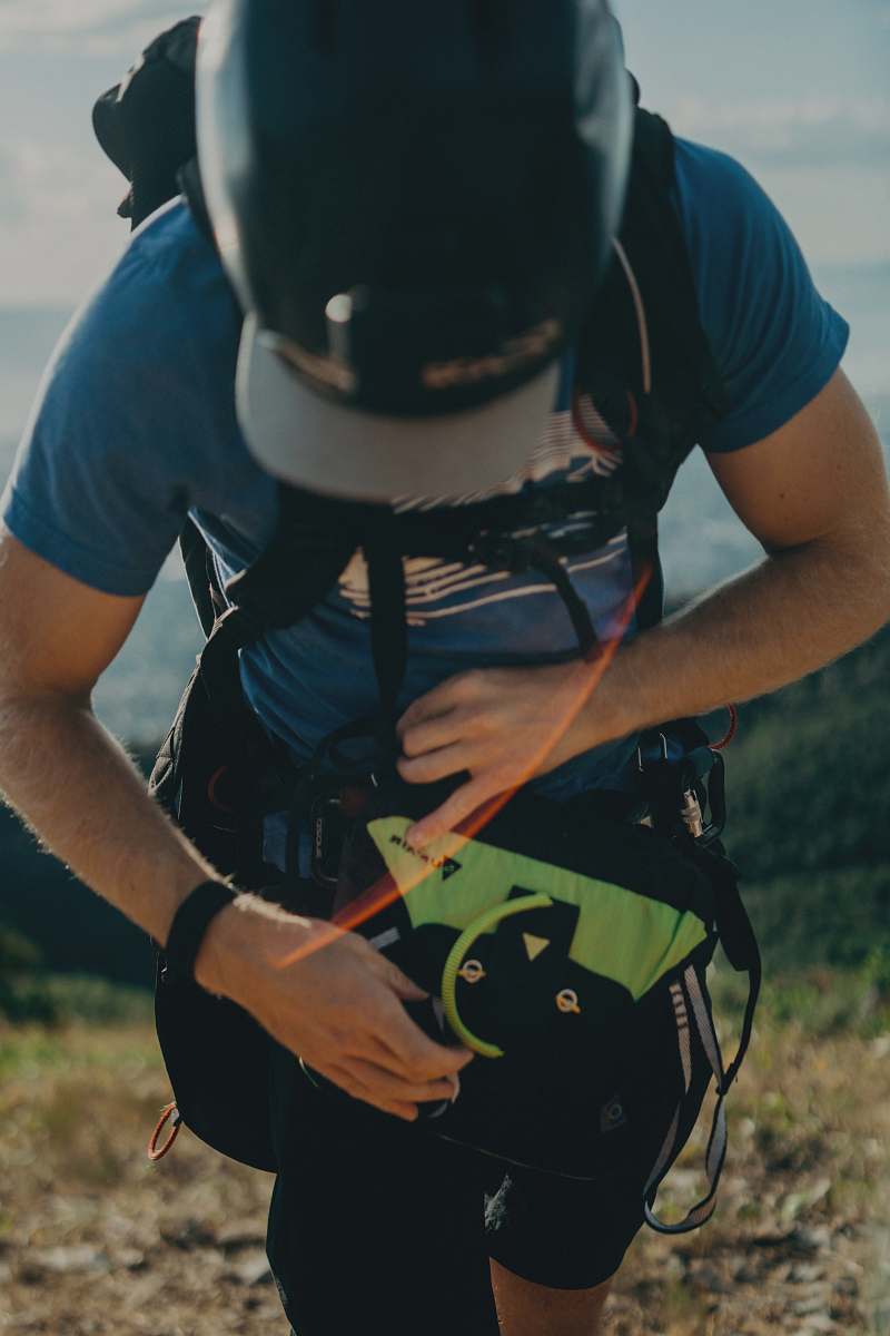 clothing man wearing hiking gear walking on field during day helmet