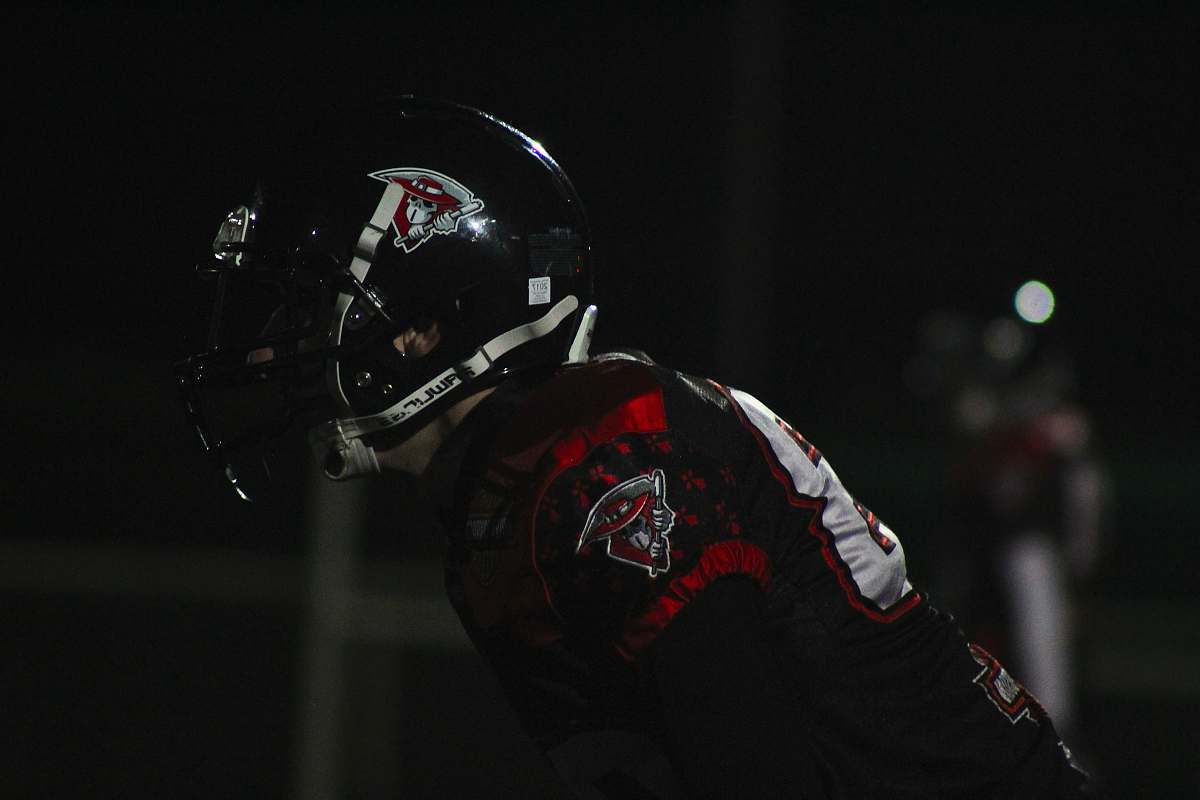 clothing man wearing red-and-black jersey shirt and black-and-white sports helmet helmet
