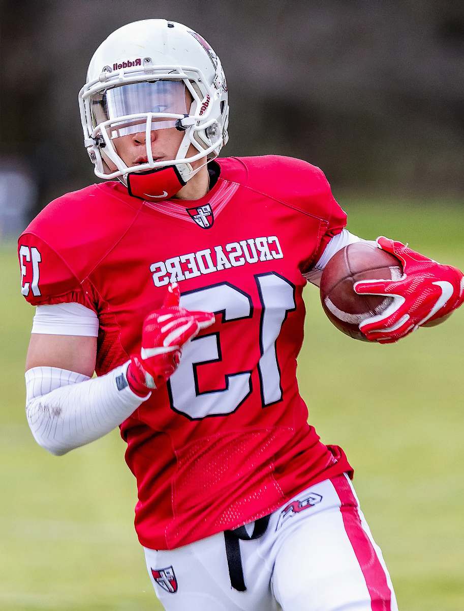 clothing man wearing red and white Western Crusaders 13 jersey shirt helmet