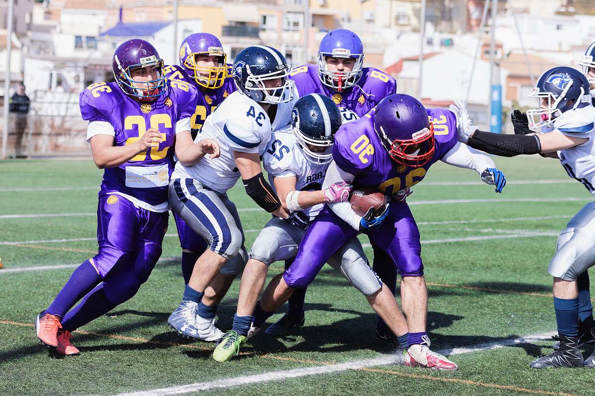 clothing men playing American football during daytime helmet