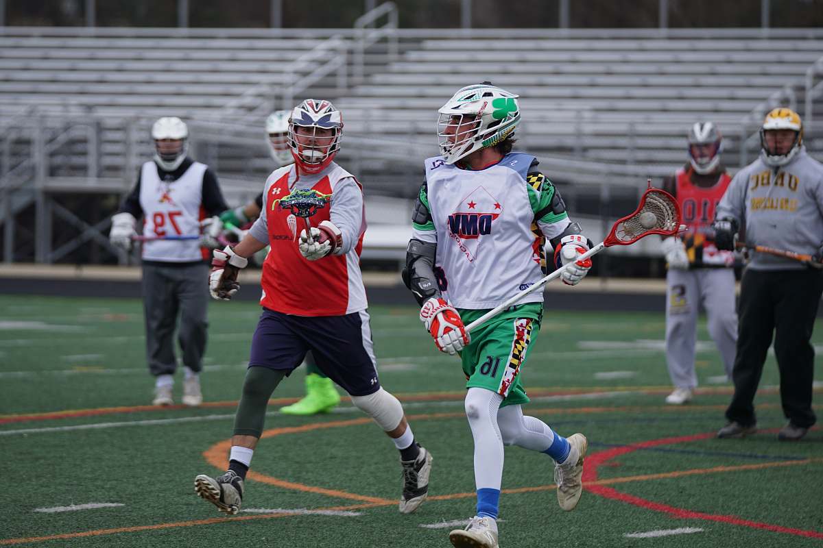 person men playing lacrosse during daytime human