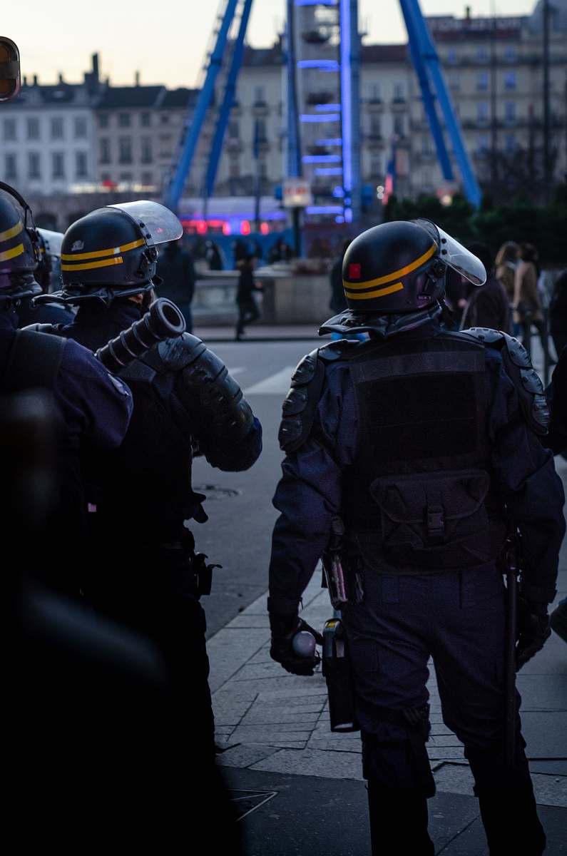clothing officers standing on pavement road helmet