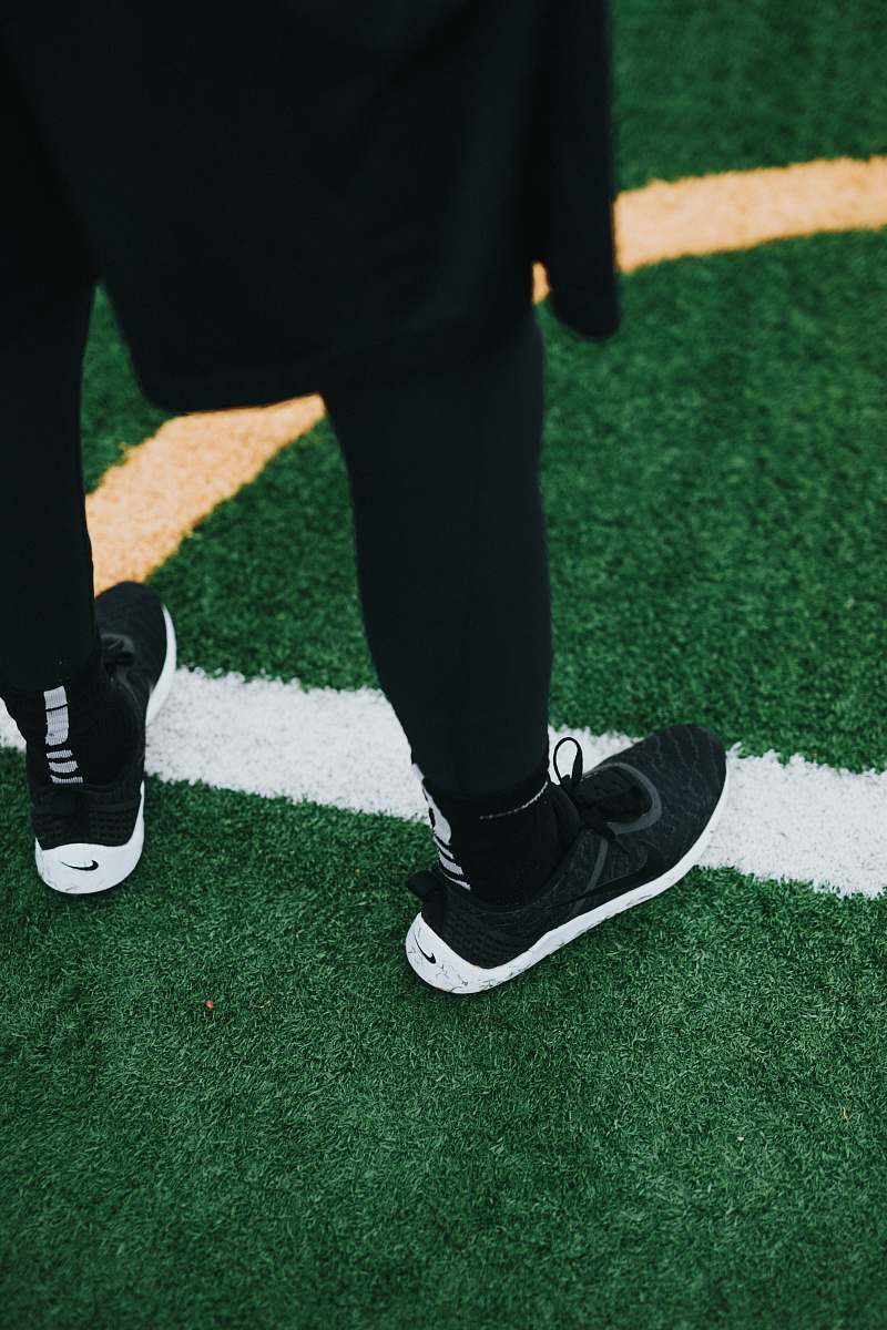 shoe person wearing black Nike shoes footwear