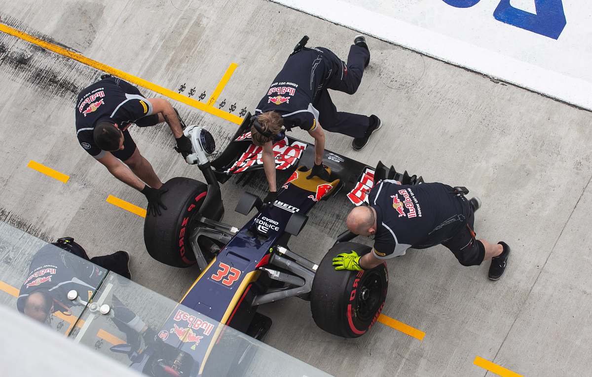 clothing three men at pit stop fixing formula one vehicle footwear