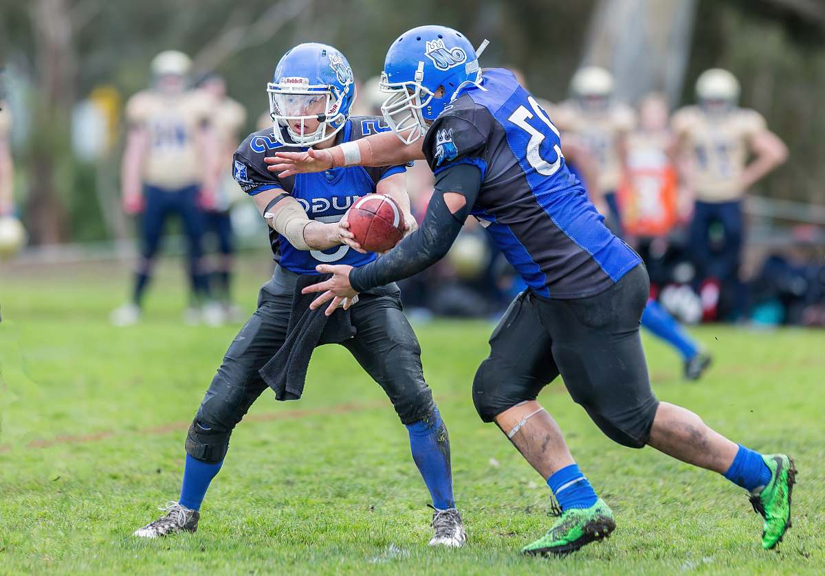 clothing time-lapse photography of men playing football in field helmet
