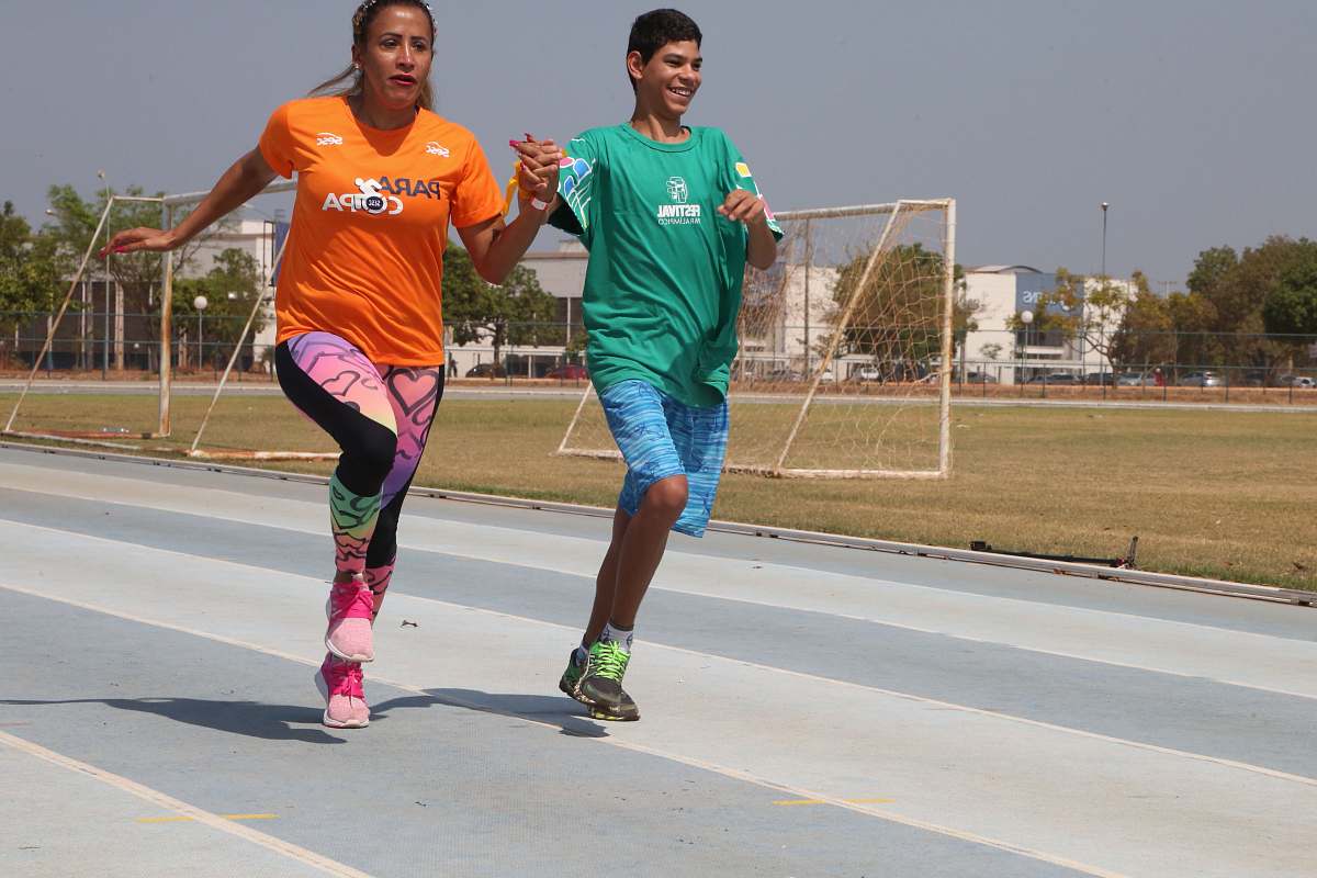 human two man and boy running on track field during daytime person