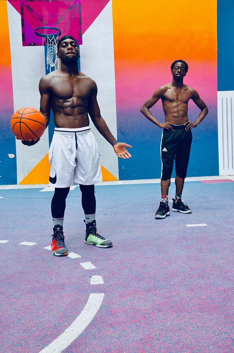 clothing two men standing near basketball hoop footwear