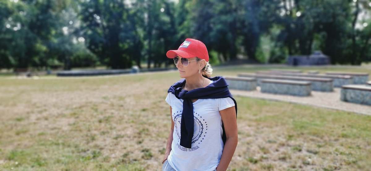 clothing woman standing on grass field near trees human