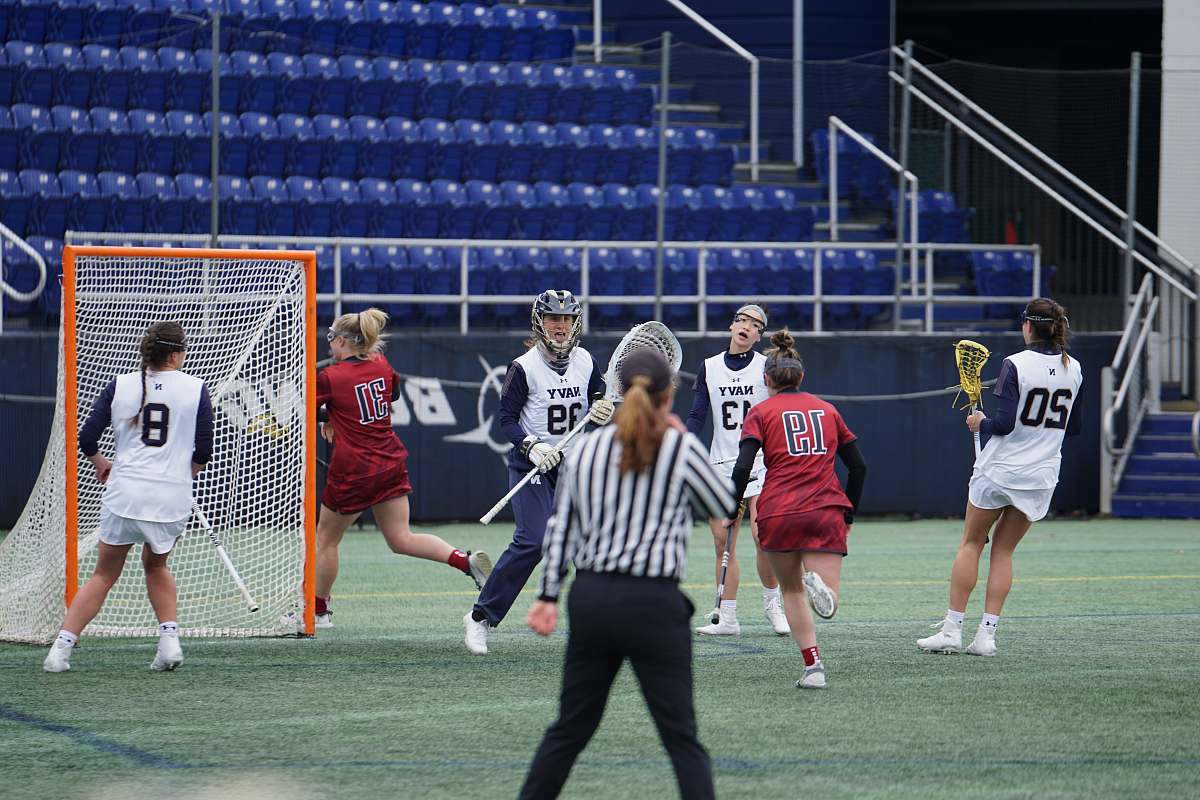 human women playing lacrosse person