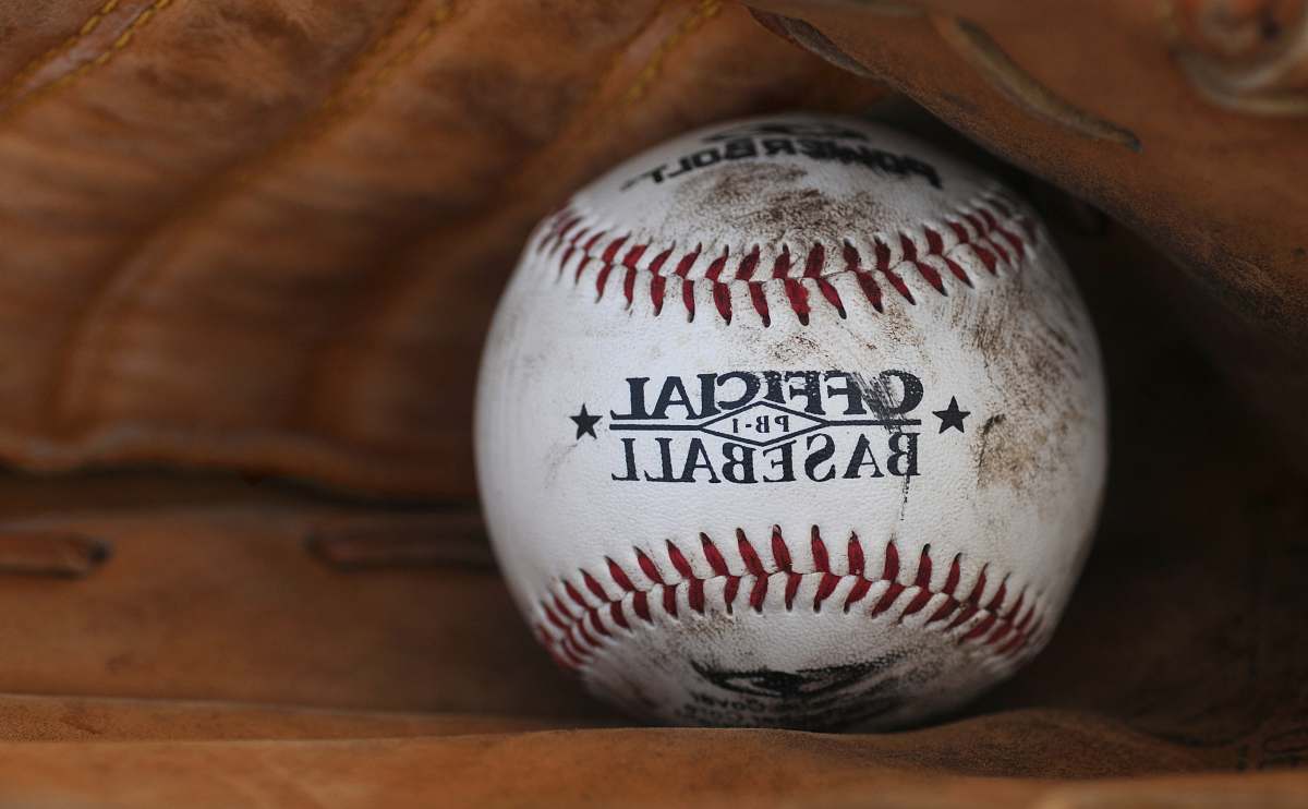 sport dirt covered Official Baseball ball in person's baseball mitts sports