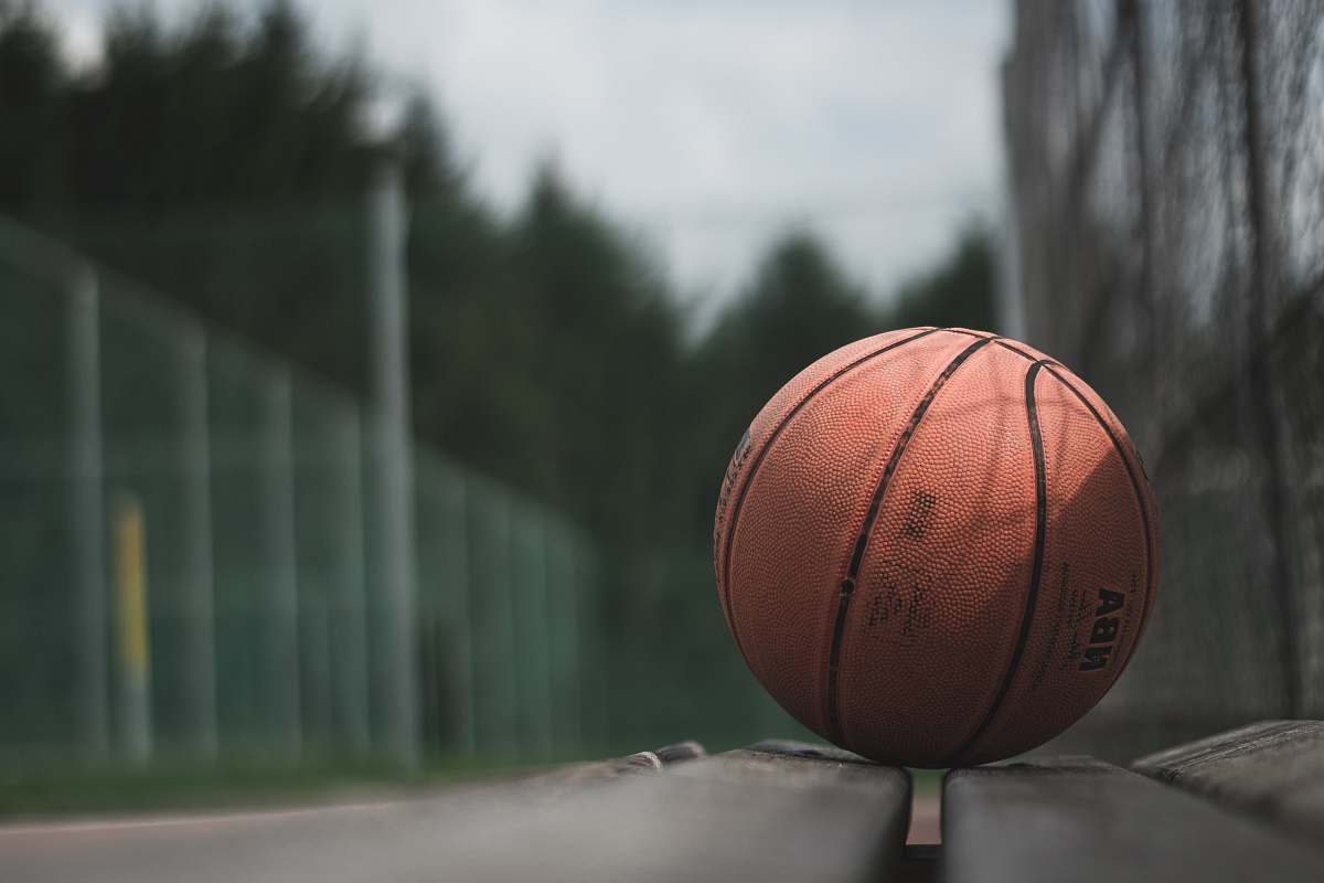sport macro photography of brown NBA basketball ball on concrete surface sports